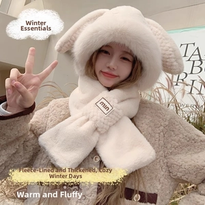 Detail of plush cream rabbit ear hood with integrated scarf and soft faux fur texture
