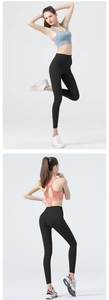 Close-up of high-waisted black yoga leggings featuring side pockets and elastic fabric