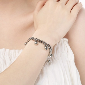 Polished silver bell bracelet for women featuring five minimalist charms on a chain