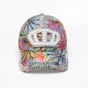 Detail of colorful floral baseball cap with pearl crown and rhinestone-studded brim