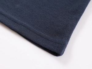 Macro detail of high-quality stitching on dark blue polo shirt fabric and texture