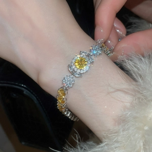 Detail of yellow zircon flower bracelet with sparkling stones on a wrist with luxury feel