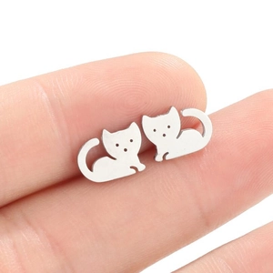 Minimalist silver cat ear studs in stainless steel shown to scale on fingertips