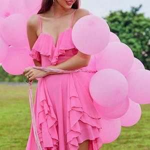 Detail of hot pink ruffles and delicate spaghetti straps on elegant evening dress