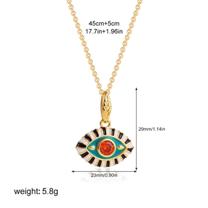 Detail showing 18K gold evil eye pendant dimensions 29x23mm and colorful enamel accents