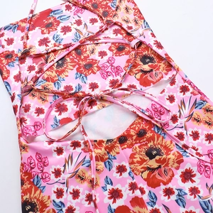 Close-up of the elegant backless lace-up design on this floral pink summer dress
