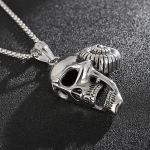 Macro view of silver punk ram skull pendant with horns and box chain necklace