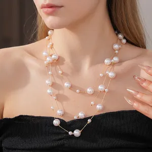 Three-layer faux pearl necklace with gold metal chain on a model for vintage styling