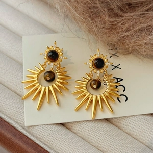 Vintage gold starburst stud earrings with tiger eye stone and zircons on white card
