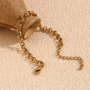 Macro detail of 14K gold plated stainless steel wheat chain bracelet with lobster clasp