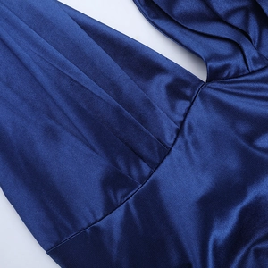Detailed view of the deep blue satin fabric showing elegant pleated texture and silk sheen