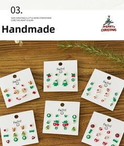 Macro view of Christmas stud earrings set featuring festive trees and gingerbread men