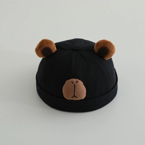 Detail of high-density cotton twill fabric and plush bear ears on black docker hat
