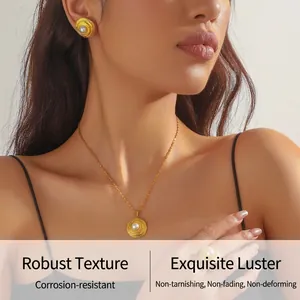 Detail of model wearing vintage 18K gold plated pearl jewelry set with spiral textures