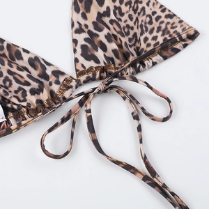 Close-up of leopard print bikini fabric showing side tie detail and stitching quality