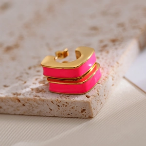 Macro shot of geometric hot pink and gold enamel U-shaped stainless steel earrings
