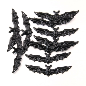 Detailed view of black bat charms in flying and hanging poses for DIY jewelry making