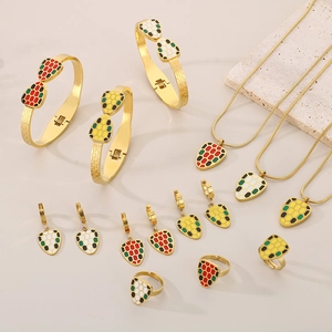 Exaggerated golden jewelry set with colorful enamel snake scale pattern details