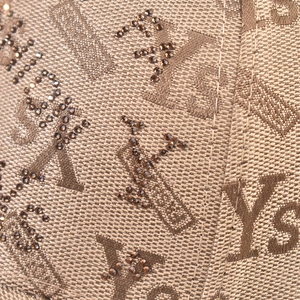 Macro view of brown jacquard fabric with YS letter pattern and dark brown rhinestones