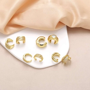 Elegant 18k gold plated heart ear cuff set with zircon stones on silk background