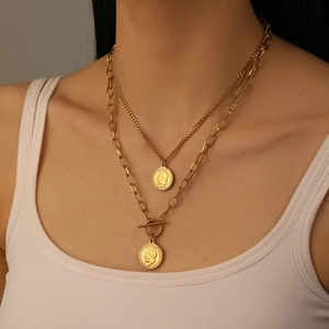 Close-up of gold-plated double-layer necklace with OT toggle clasp and coin pendants