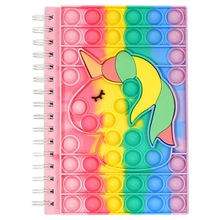 Detail of unicorn rainbow fidget notebook with pop-it silicone cover and spiral binding