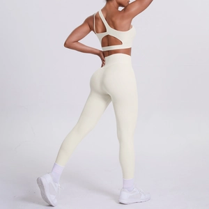 Detail view of the open-back sports bra and high-waist yoga leggings in creamy ivory white