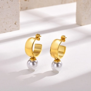 Detail of 18K gold-plated C-shape hoop earrings with white round pearl drop pendants