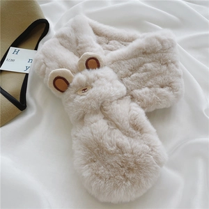 Detail of soft beige faux fur scarf featuring a cute plush bear head design
