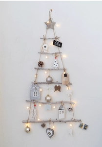 Detail of Nordic wooden wall Christmas tree with warm LED lights and holiday ornaments