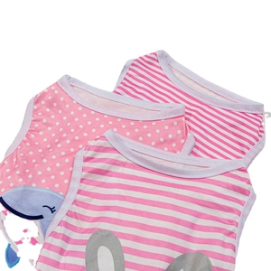 Pink cotton pet vests with polka dots and stripes in a stacked flat lay display