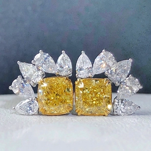 Detail of luxury teardrop earrings with yellow cushion-cut stones and pear-shaped zircon
