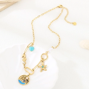 Detail view of gold stainless steel ocean necklace with starfish charms in seashell tray