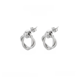 Detailed view of 16mm twisted knot stud earrings in polished stainless steel