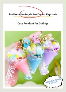 Detail of acrylic ice cream keychain with floating macaron beads and gold bell