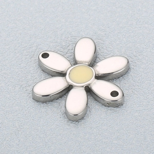 Macro view of a stainless steel daisy charm with six petals and a beige enamel center