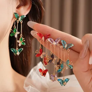 Boucles d'oreilles papillon avec pierres en zircon et longs pompons en plusieurs couleurs