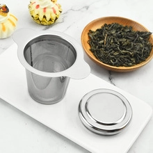 Close-up of 304 stainless steel tea infuser with dual handles on a white tray
