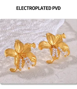 Detail of PVD gold plated flower earrings with elegant white pearl tassels
