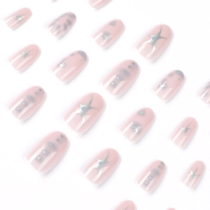 Short oval light pink press-on nails with silver star patterns and gray dots
