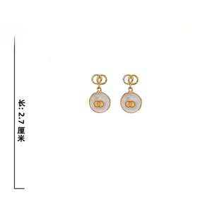 Detail view showing dimensions of shell earrings with 925 silver needles and gold alloy
