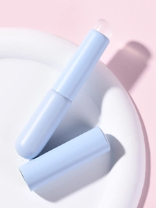 Close-up of light blue matte silicone lip brush with a translucent protective cap