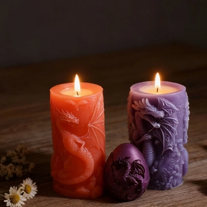 Embossed flying dragon pillar and egg-shaped candle set in vibrant orange and purple