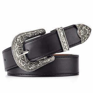 Detail of western style black leather belt with ornate silver floral engraved buckle and tip