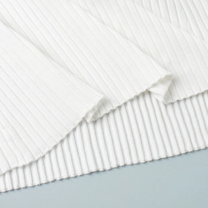 Close-up of premium white ribbed knit fabric texture and high-quality hem detail