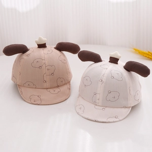 Detail of baby sun hats featuring cute puppy patterns and 3D plush ears on white background