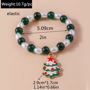 Detail of Christmas beaded bracelet with green and white pearls and a Xmas tree charm