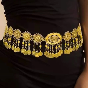 Detail of bohemian gold metal waist chain with hollow butterfly charms and tassel coins