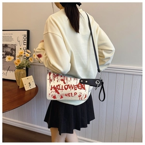 Detail of creative cleaver bag with bloody Halloween prints and black shoulder strap