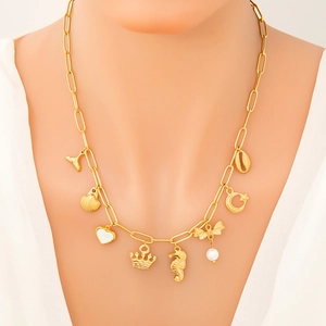 Gold plated stainless steel ocean theme necklace featuring shell and whale tail charms